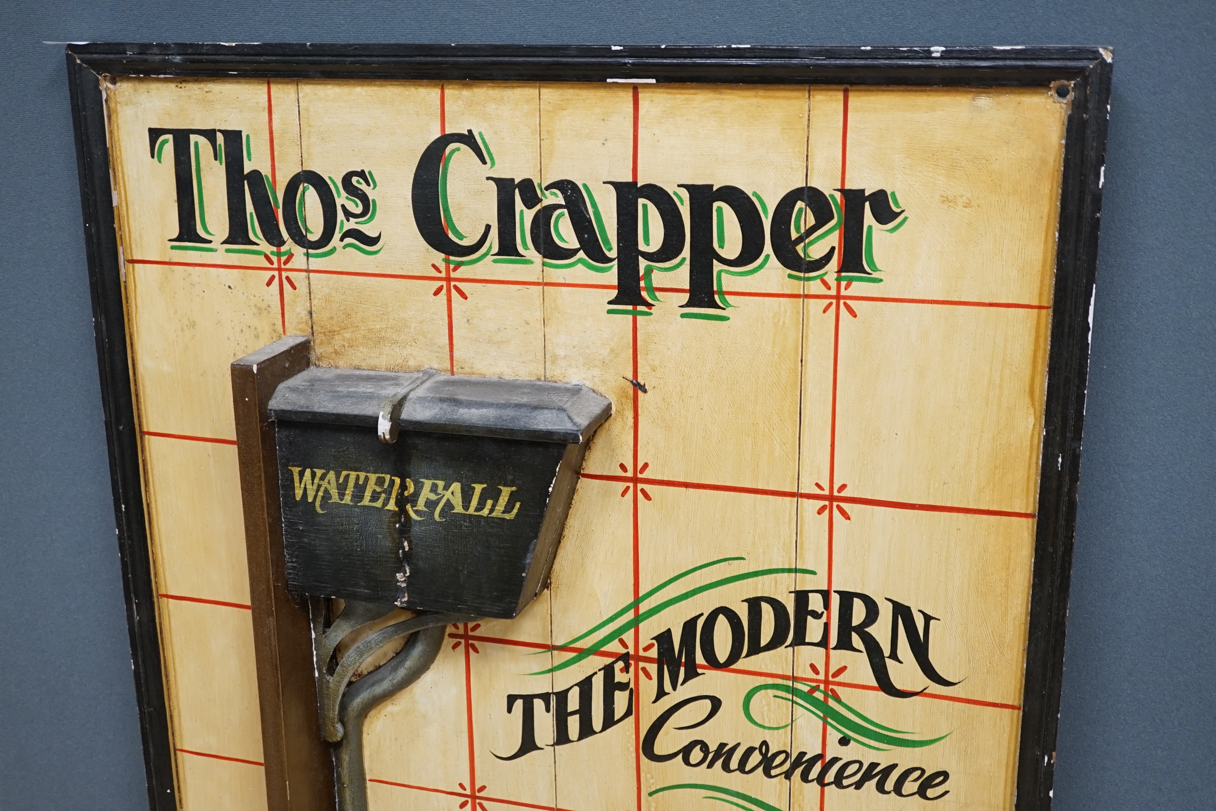 A ‘Thomas Crapper’ painted wood advertising sign, 91 x 61cm